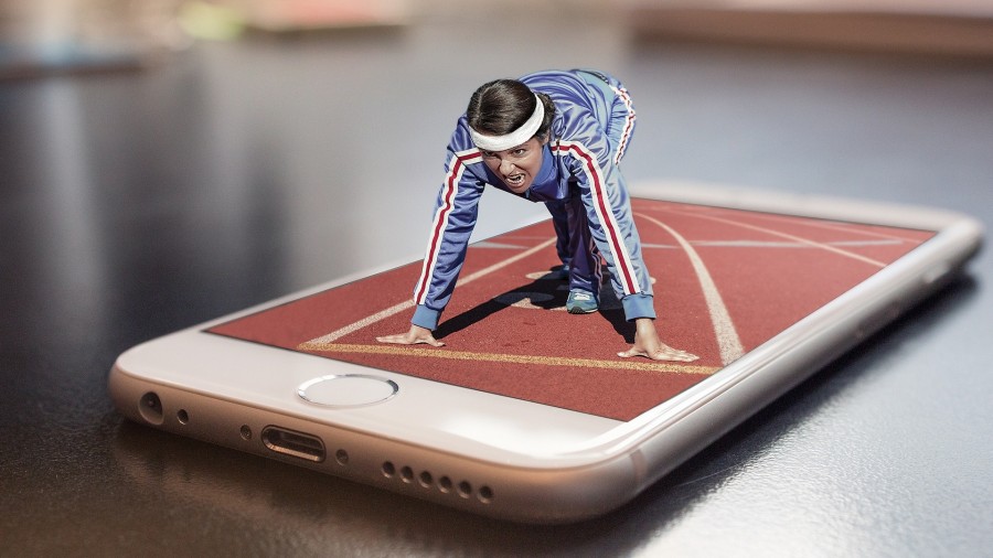 Das Foto zeigt eine Läuferin in Sportdress und in Startposition auf einer Leichtathletikbahn, die sich auf einem Handy befindet. So wird das Thema Digitalisierung im Sport angesprochen. Mülheimer SportService, Mülheimer Sportbund. - Composita auf Pixabay