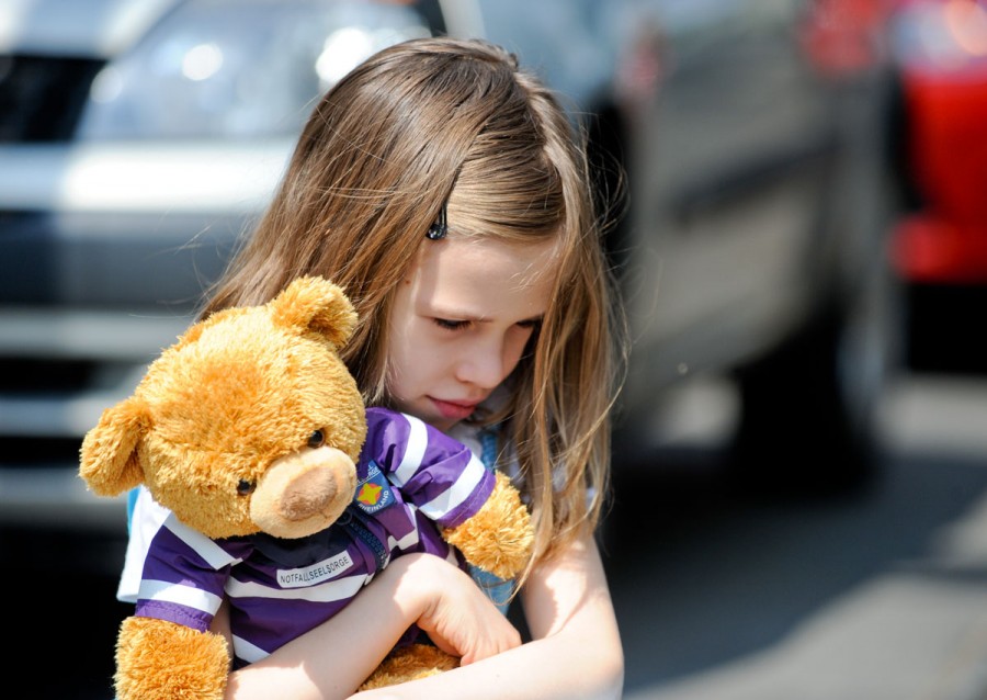 Kleines Mädchen klammert sich an ihren Teddybären. In zahlreichen Unfallsituationen ist speziell die Betreuung von Kindern in traumatischen Situationen nötig und wichtig. - Andeas Köhring