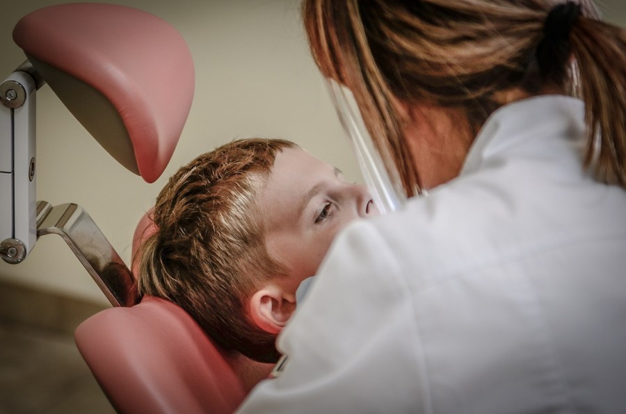 Zahnärztin untersucht die Zähne eines Kindes. Infos zum zahnärztlichen Gesundheitsdienst. - Pixabay