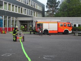 Schläuche werden ausgerollt. Ein Feuer in einem Klassenraum der Gesamtschule Saarn war Grund für einen Großalarm der Feuerwehr Mülheim.